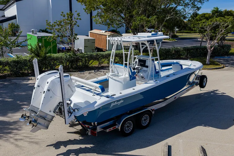 Slide: The Image of 2026 Yellowfin 26 Hybrid boat on trailer, parked outdoors, featuring dual engines. - 40