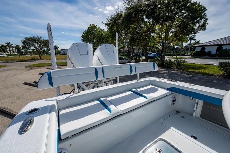 Slide: The Image of 2026 Yellowfin 26 Hybrid boat with dual Mercury engines, parked outdoors. - 41