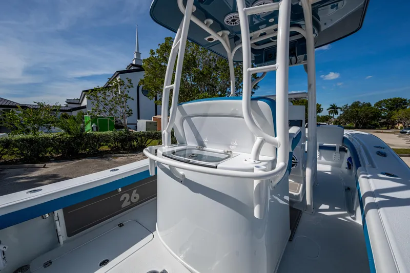 Slide: The Image of 2026 Yellowfin 26 Hybrid boat with sleek design, parked outdoors under clear blue sky. - 43