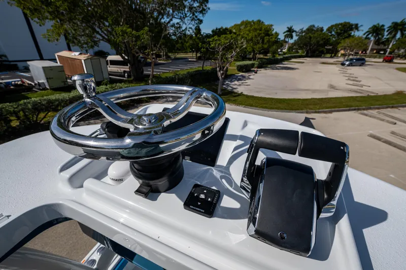 Slide: The Image of Steering console of 2026 Yellowfin 26 Hybrid boat with controls and steering wheel. - 45