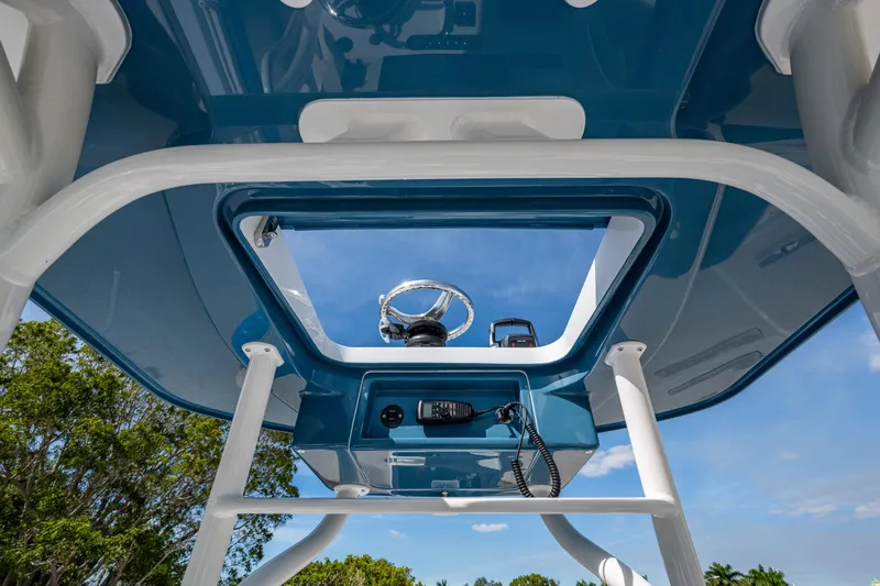 Slide: The Image of 2026 Yellowfin 26 Hybrid boat console with steering wheel and communication equipment. - 47