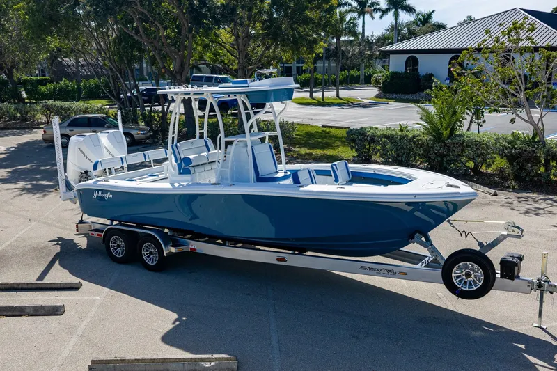 Slide: The Image of 2026 Yellowfin 26 Hybrid boat on trailer, parked in sunny lot. - 49