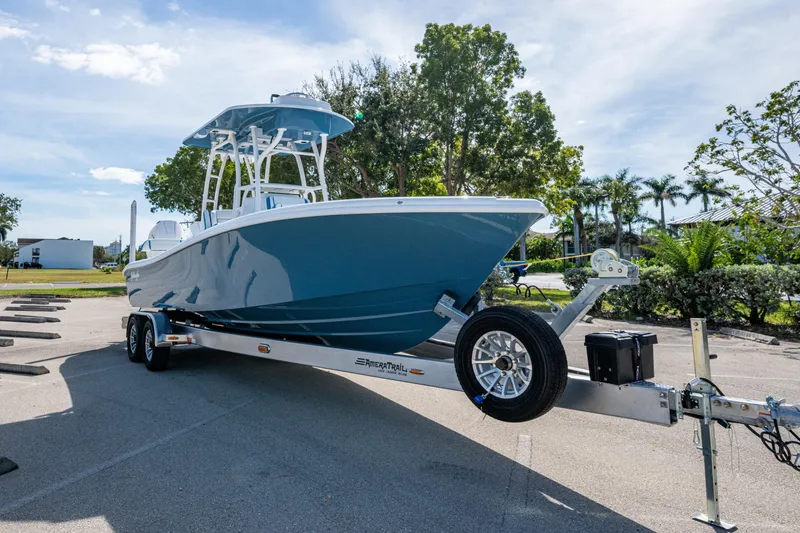 Slide: The Image of 2026 Yellowfin 26 Hybrid boat on trailer in sunny outdoor setting. - 6