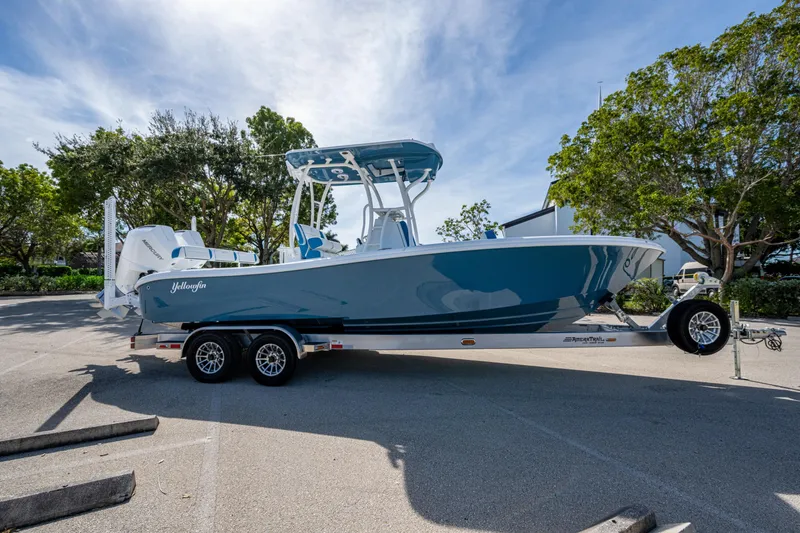 Slide: The Image of 2026 Yellowfin 26 Hybrid boat on trailer, parked outdoors under a clear sky. - 7