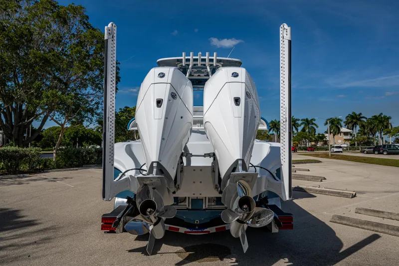 Slide: The Image of 2026 Yellowfin 26 Hybrid boat with dual outboard engines in a sunny parking lot. - 8