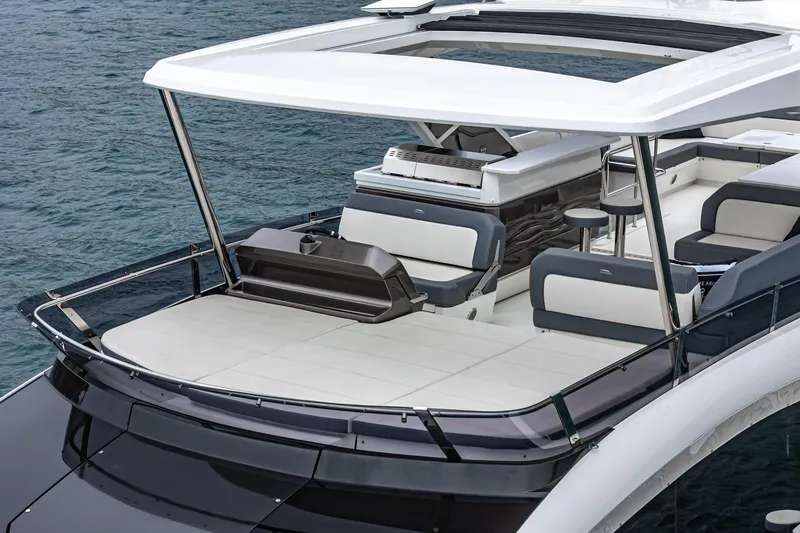 Slide: The Image of 2023 Galeon 640 Fly yacht with spacious deck and modern seating on the water. - 11