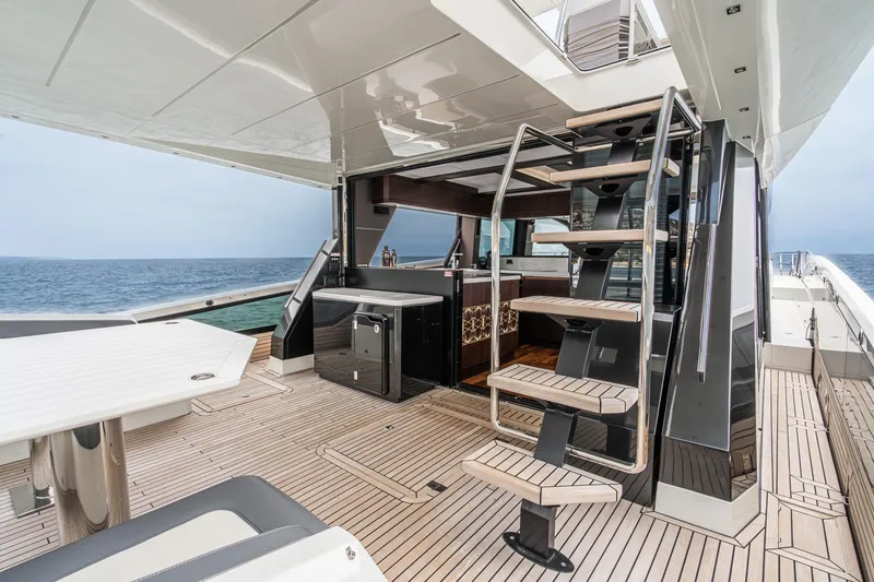 Slide: The Image of 2023 Galeon 640 Fly yacht deck with modern staircase and ocean view. - 13