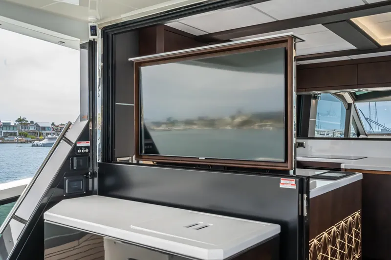 Slide: The Image of 2023 Galeon 640 Fly yacht interior with retractable TV and modern design. - 15