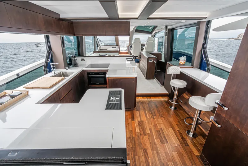 Slide: The Image of Luxurious interior of 2023 Galeon 640 Fly yacht with modern kitchen and seating area. - 17