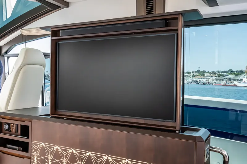 Slide: The Image of Luxurious interior of 2023 Galeon 640 Fly yacht with retractable TV and scenic ocean view. - 25