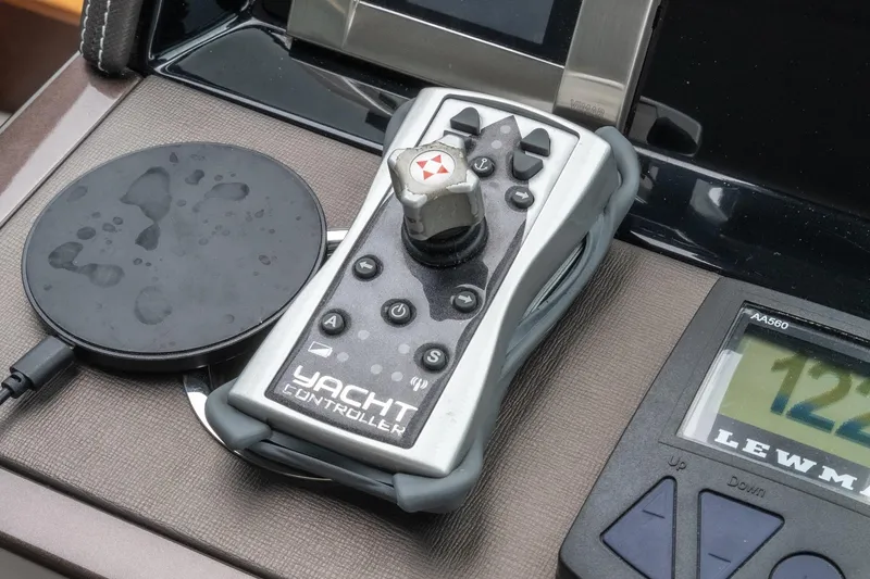 Slide: The Image of Yacht controller on 2023 Galeon 640 Fly dashboard, featuring joystick and control buttons. - 30