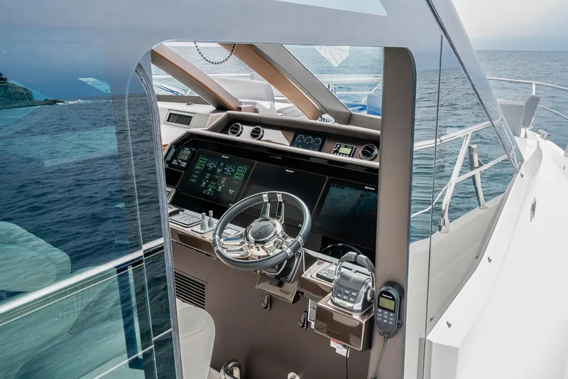 Slide: The Image of 2023 Galeon 640 Fly yacht helm with advanced navigation systems on open sea. - 31