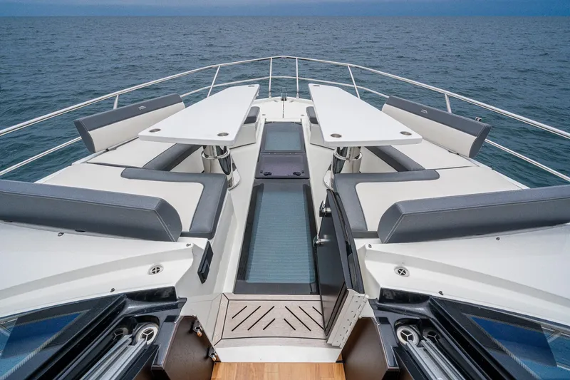 Slide: The Image of 2023 Galeon 640 Fly yacht deck with seating and tables, overlooking the ocean. - 34