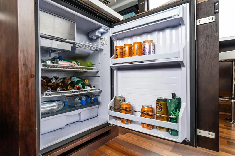 Slide: The Image of Open fridge on Galeon 640 Fly yacht, stocked with drinks and beverages, 2023 model. - 49