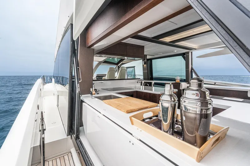 Slide: The Image of 2023 Galeon 640 Fly yacht with sleek outdoor bar and ocean view. - 51