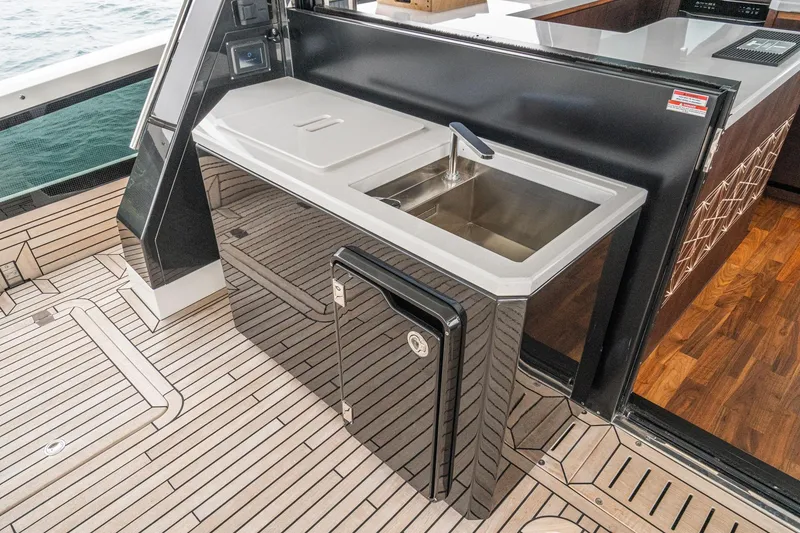 Slide: The Image of Luxury yacht Galeon 640 Fly 2023, featuring sleek outdoor kitchen with sink and modern design. - 52