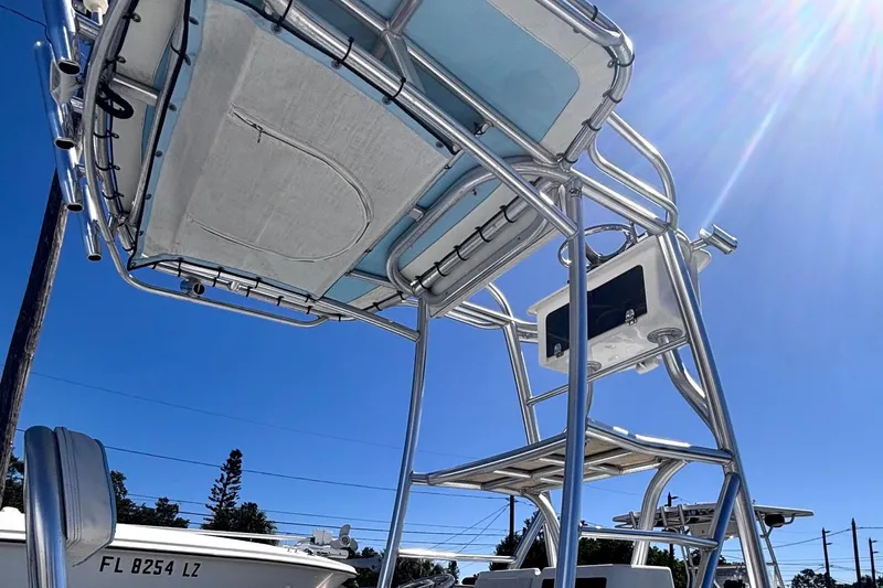 Slide: The Image of 1974 Aquasport 2400 Center Console boat with T-top under clear blue sky. - 11