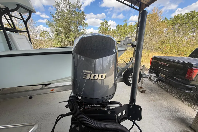 Slide: The Image of 1974 Aquasport 2400 Center Console with Yamaha 300 outboard motor, parked near a GMC truck. - 20