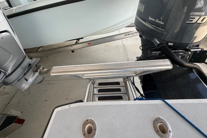 Slide: The Image of 1974 Aquasport 2400 Center Console with Yamaha outboard motor, docked on trailer. - 22