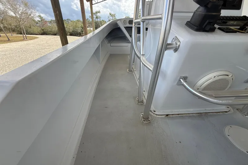Slide: The Image of 1974 Aquasport 2400 Center Console boat interior with metal railings and spacious deck. - 24