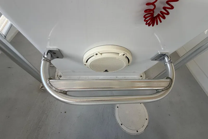 Slide: The Image of 1974 Aquasport 2400 Center Console boat interior with metal railing and speaker. - 25