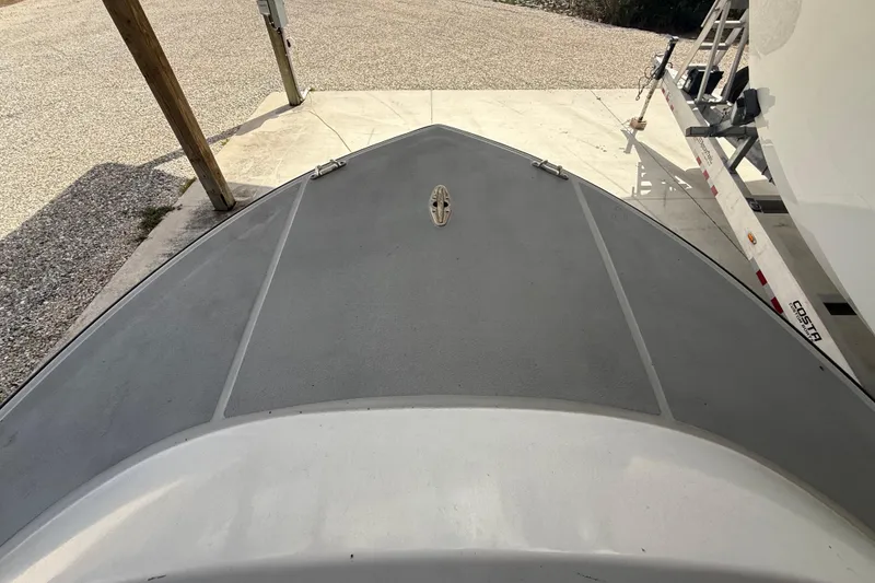 Slide: The Image of 1974 Aquasport 2400 Center Console boat deck, parked on a concrete surface. - 29