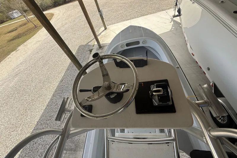 Slide: The Image of 1974 Aquasport 2400 Center Console boat helm with steering wheel and controls. - 33