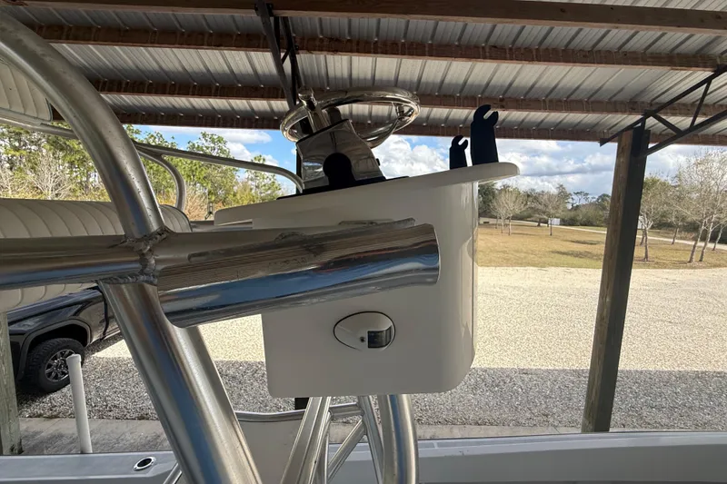 Slide: The Image of 1974 Aquasport 2400 Center Console boat under a metal canopy, showcasing steering console. - 36