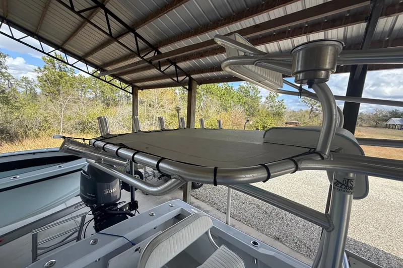 Slide: The Image of 1974 Aquasport 2400 Center Console boat under a metal canopy, featuring a powerful outboard motor. - 37