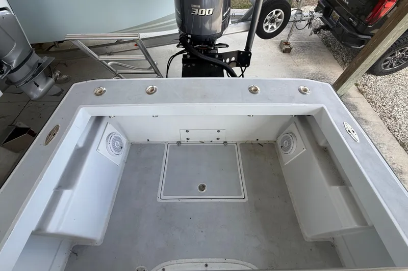 Slide: The Image of 1974 Aquasport 2400 Center Console boat interior with Yamaha 300 engine in a garage. - 39