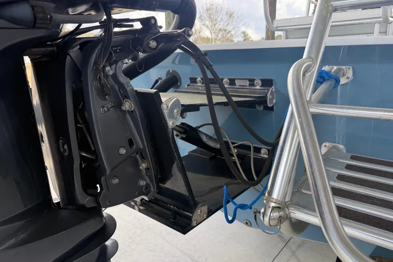 Slide: The Image of 1974 Aquasport 2400 Center Console boat engine and ladder detail. - 45