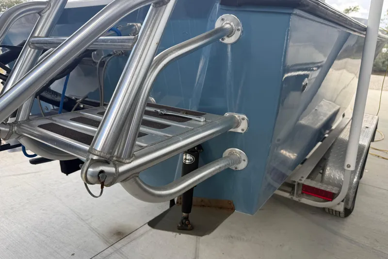 Slide: The Image of 1974 Aquasport 2400 Center Console boat with stainless steel ladder and blue hull. - 46