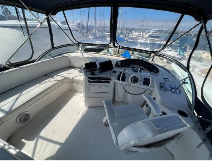 Slide: The Image of 1997 Bayliner 3788 Command Bridge Motoryacht cockpit with steering wheel and navigation equipment. - 10