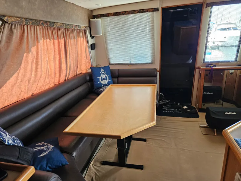 Slide: The Image of Interior of 1997 Bayliner 3788 Command Bridge Motoryacht with seating and table. - 13