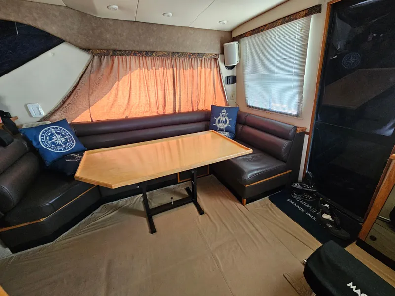 Slide: The Image of Interior of 1997 Bayliner 3788 Command Bridge Motoryacht with cozy seating and table. - 14