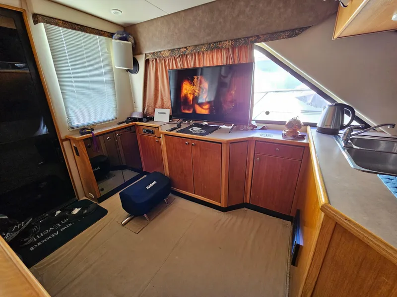 Slide: The Image of Interior of 1997 Bayliner 3788 Command Bridge Motoryacht with cozy living area and modern amenities. - 15
