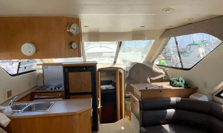 Slide: The Image of Interior of 1997 Bayliner 3788 Command Bridge Motoryacht with kitchen and seating area. - 17