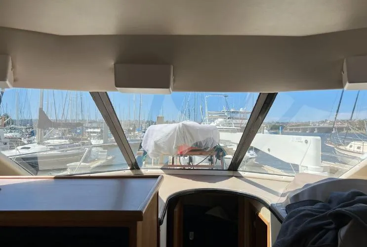 Slide: The Image of Interior view from a 1997 Bayliner 3788 Command Bridge Motoryacht, overlooking a marina. - 22