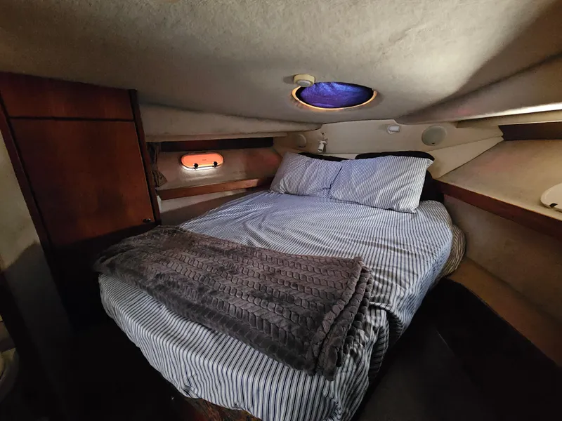 Slide: The Image of Cozy cabin interior of 1997 Bayliner 3788 Command Bridge Motoryacht with bed and porthole. - 26