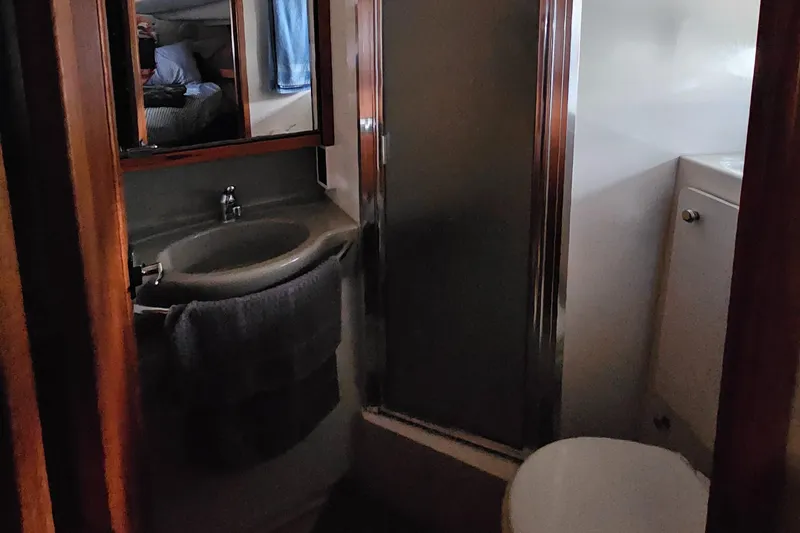 Slide: The Image of 1997 Bayliner 3788 Command Bridge Motoryacht bathroom with sink, mirror, and shower. - 27