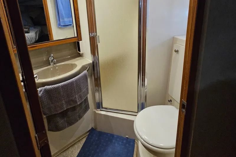 Slide: The Image of Bathroom interior of 1997 Bayliner 3788 Command Bridge Motoryacht with shower, sink, and toilet. - 28