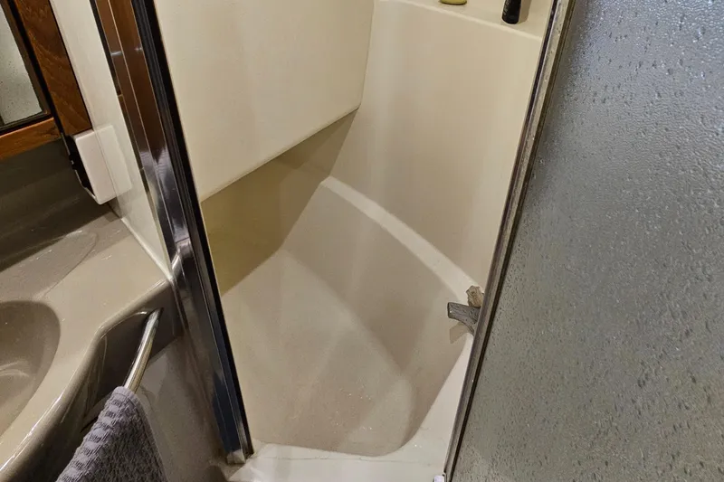 Slide: The Image of Bathroom interior of 1997 Bayliner 3788 Command Bridge Motoryacht, featuring a compact shower. - 29