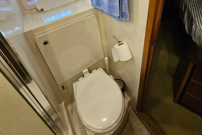 Slide: The Image of 1997 Bayliner 3788 Command Bridge Motoryacht bathroom with toilet and towel. - 30