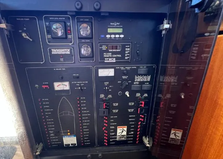 Slide: The Image of Control panel of a 1997 Bayliner 3788 Command Bridge Motoryacht, featuring various gauges and switches. - 32
