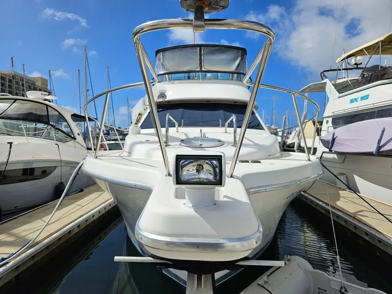 Slide: The Image of 1997 Bayliner 3788 Command Bridge Motoryacht docked at marina under blue sky. - 5