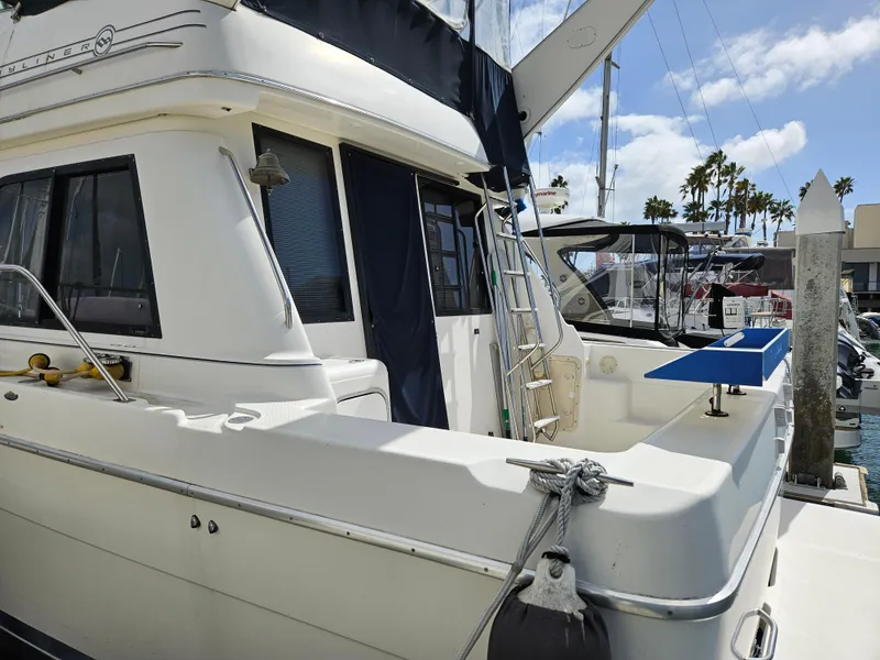 Slide: The Image of 1997 Bayliner 3788 Command Bridge Motoryacht docked at marina under clear sky. - 6
