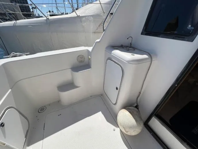 Slide: The Image of 1997 Bayliner 3788 Command Bridge Motoryacht deck with sink and storage compartment. - 9