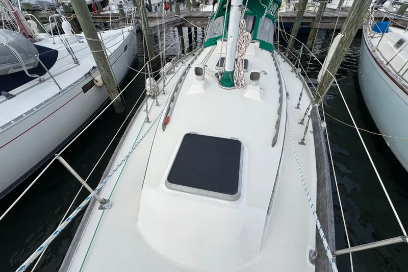 Slide: The Image of 1983 Sabre 34 sailboat docked, showing deck and rigging details. - 11