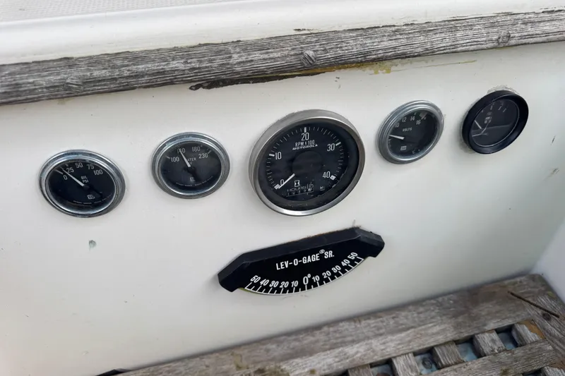 Slide: The Image of Dashboard of a 1983 Sabre 34 boat with various gauges and dials. - 19