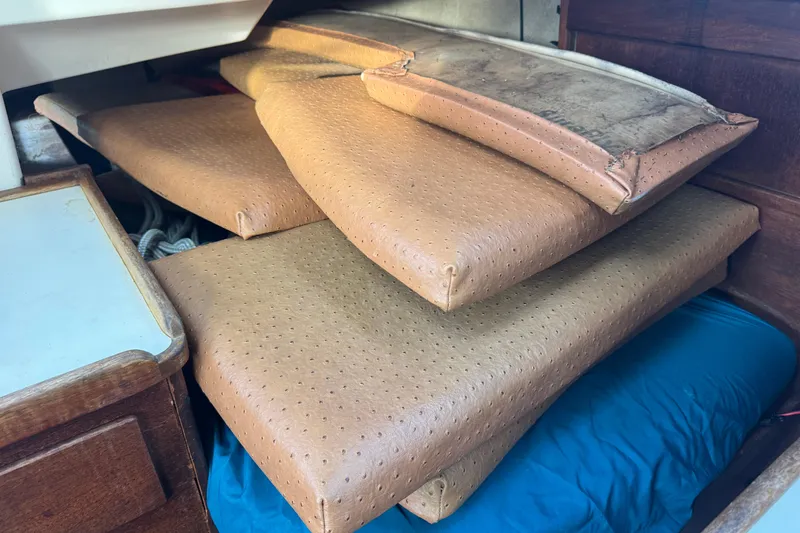 Slide: The Image of Brown cushions stacked inside a 1983 Sabre 34 sailboat cabin. - 24